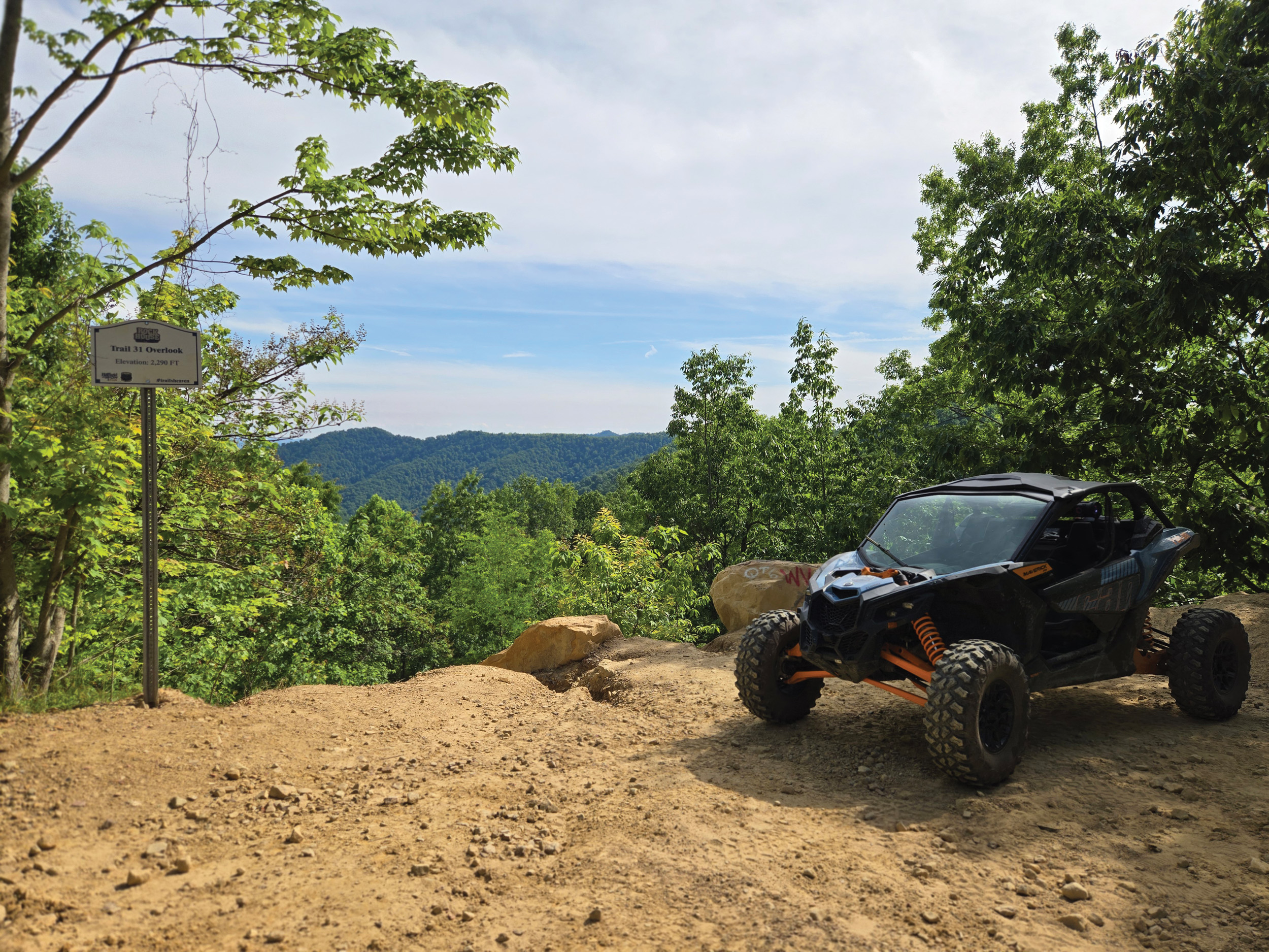 side-by-side ATV on to of a hill overlooking trees